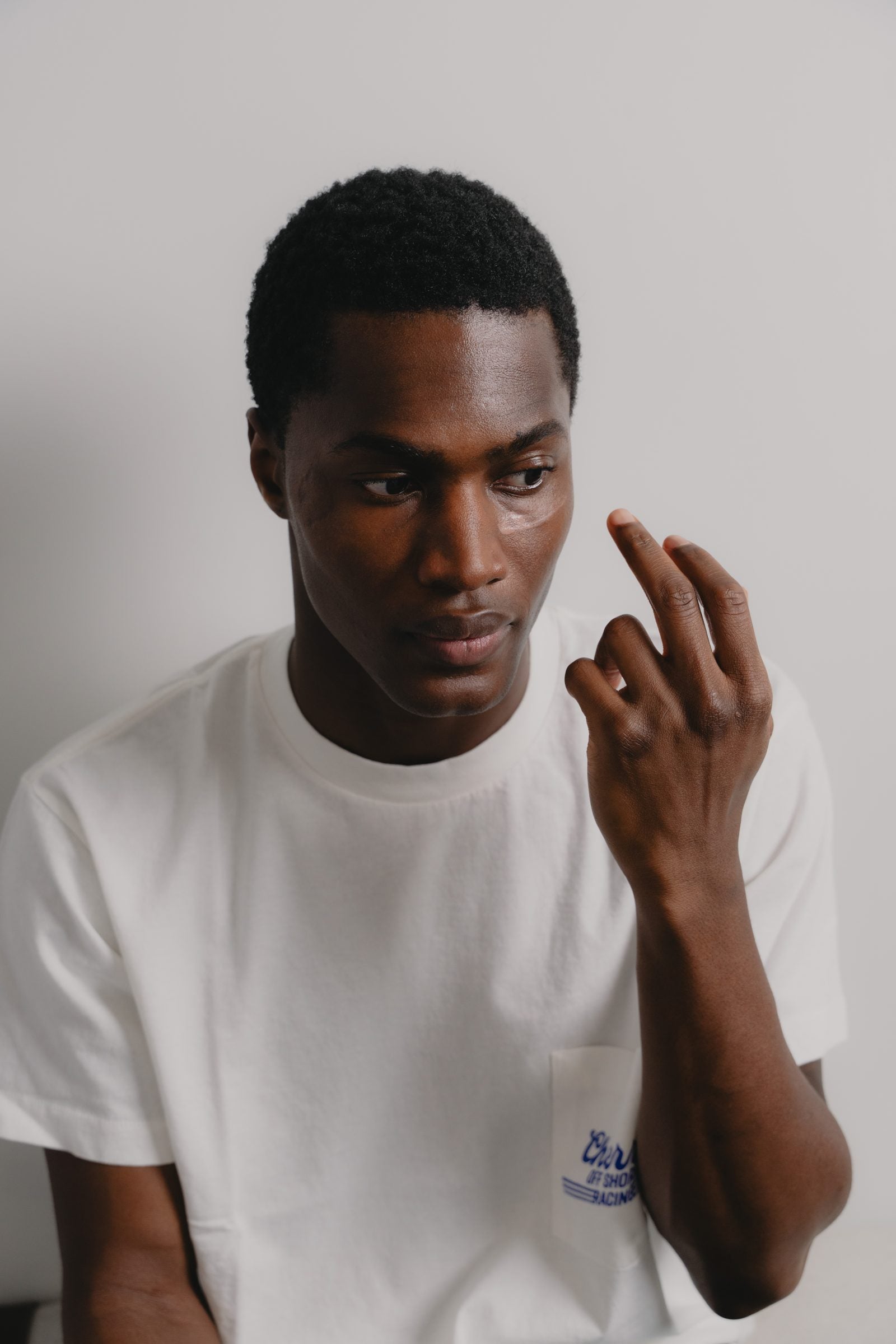 Young man touching his under-eye area — a men's guide to the best ingredients for dark circles