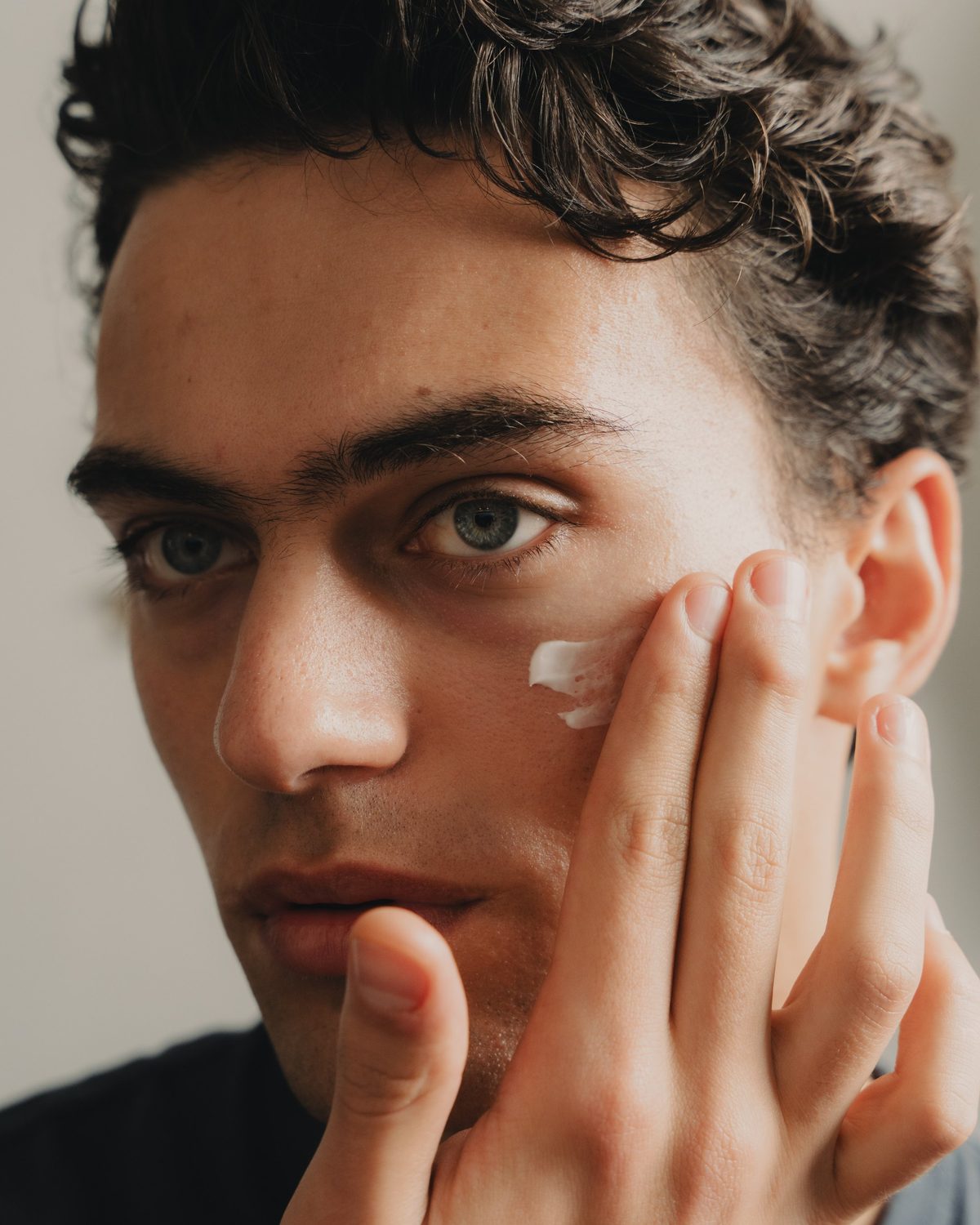 Mattifying moisturiser being smoothed along the jaw and neck after washing