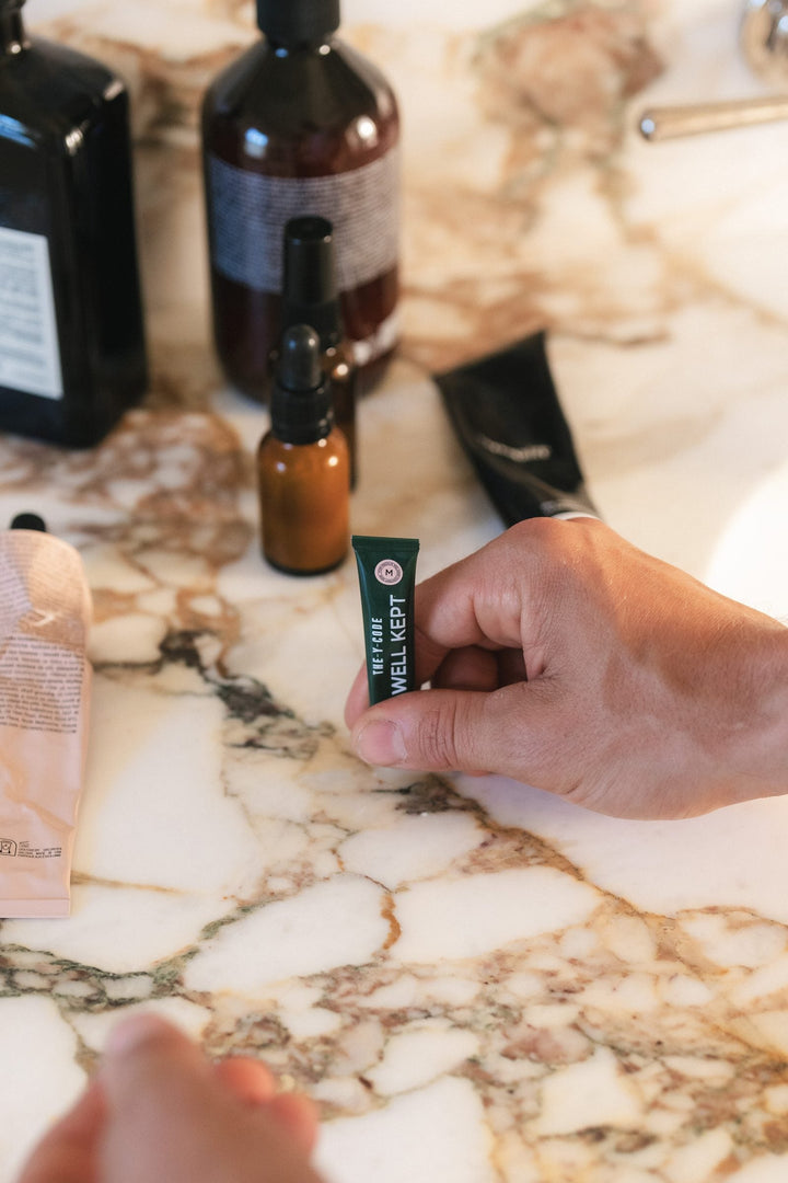 Dispensing YCODE eye serum onto a fingertip