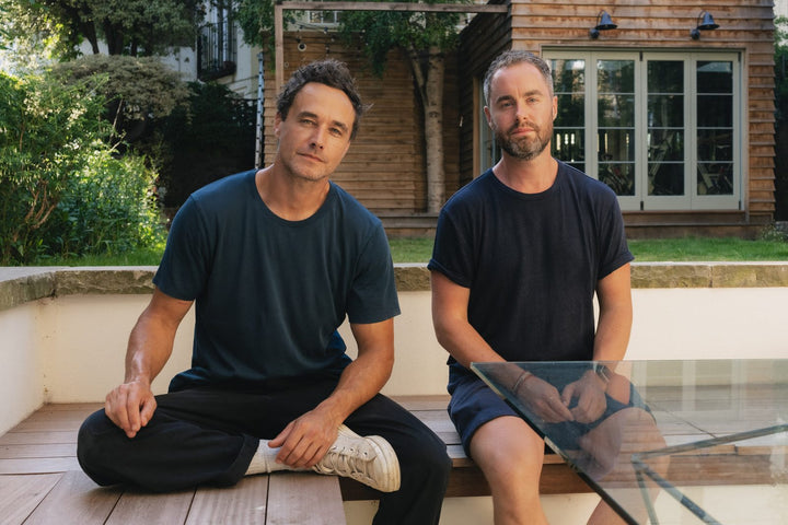 Two men sitting outside