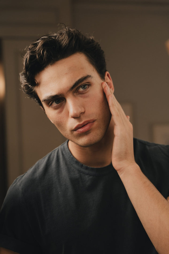 Man in his thirties at home, calm and considered — YCODE anti-ageing skincare for men in their 30s and 40s