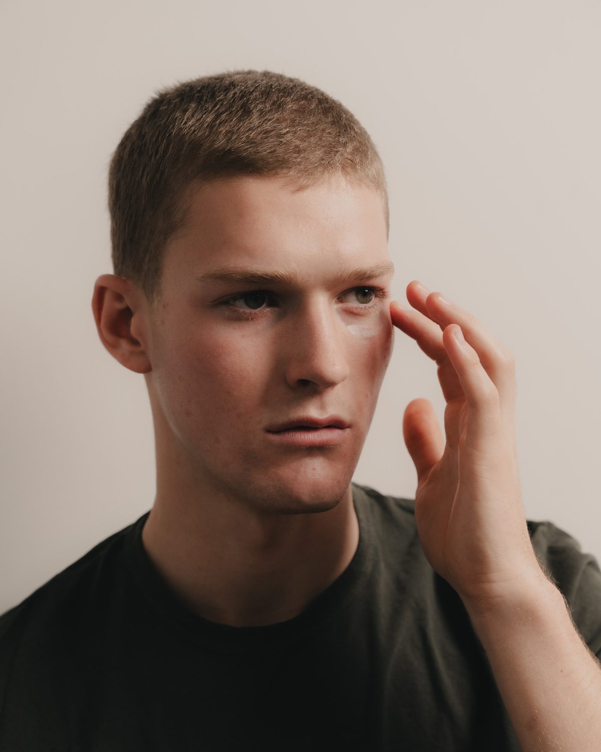 A man looking closely at his skin in daylight after two weeks of use