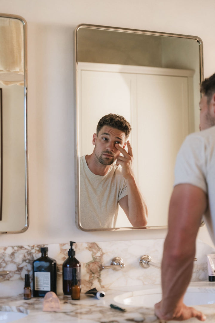 A man at the bathroom mirror after washing