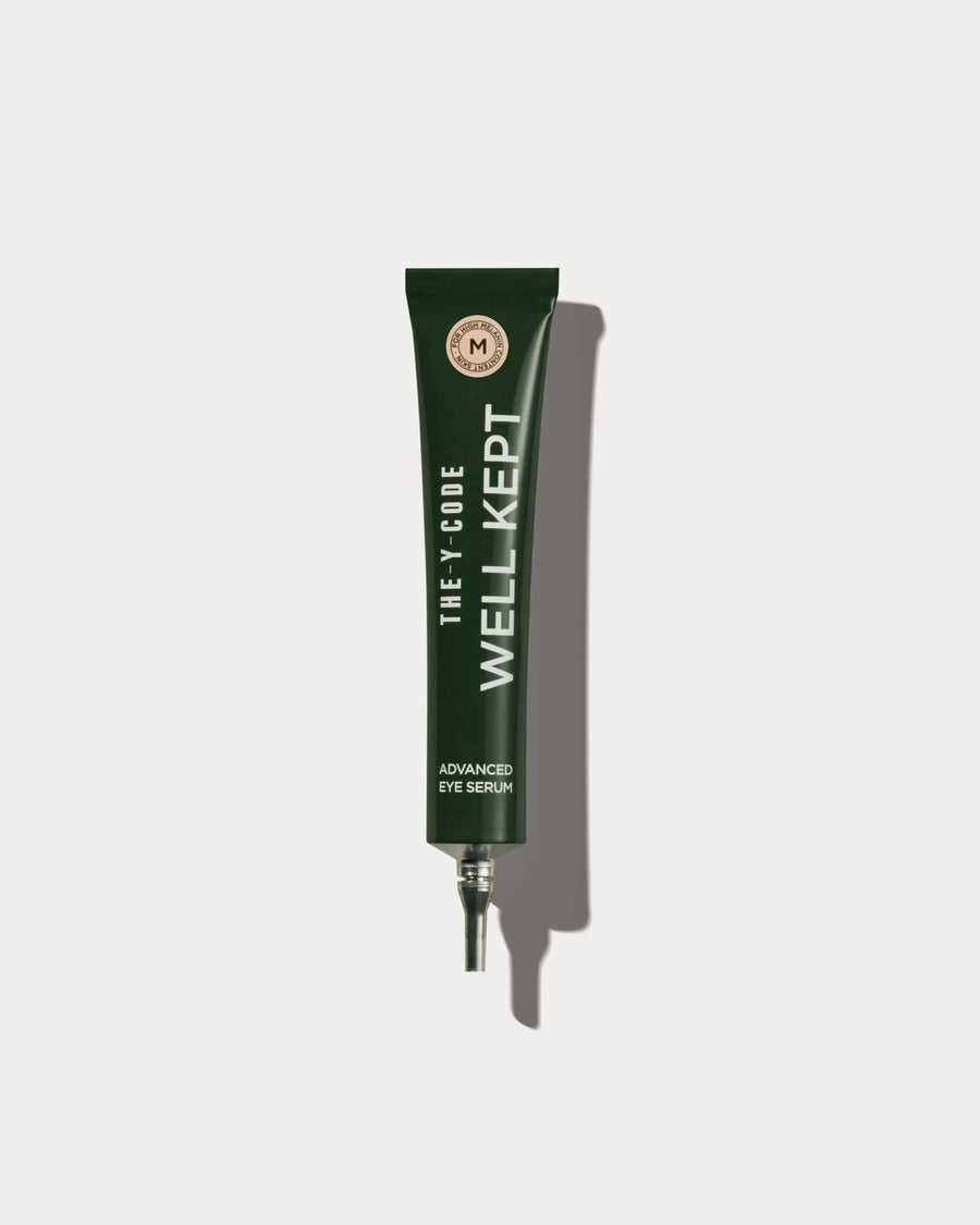 YCODE Advanced Eye Serum for men, dark green tube front view on a beige background