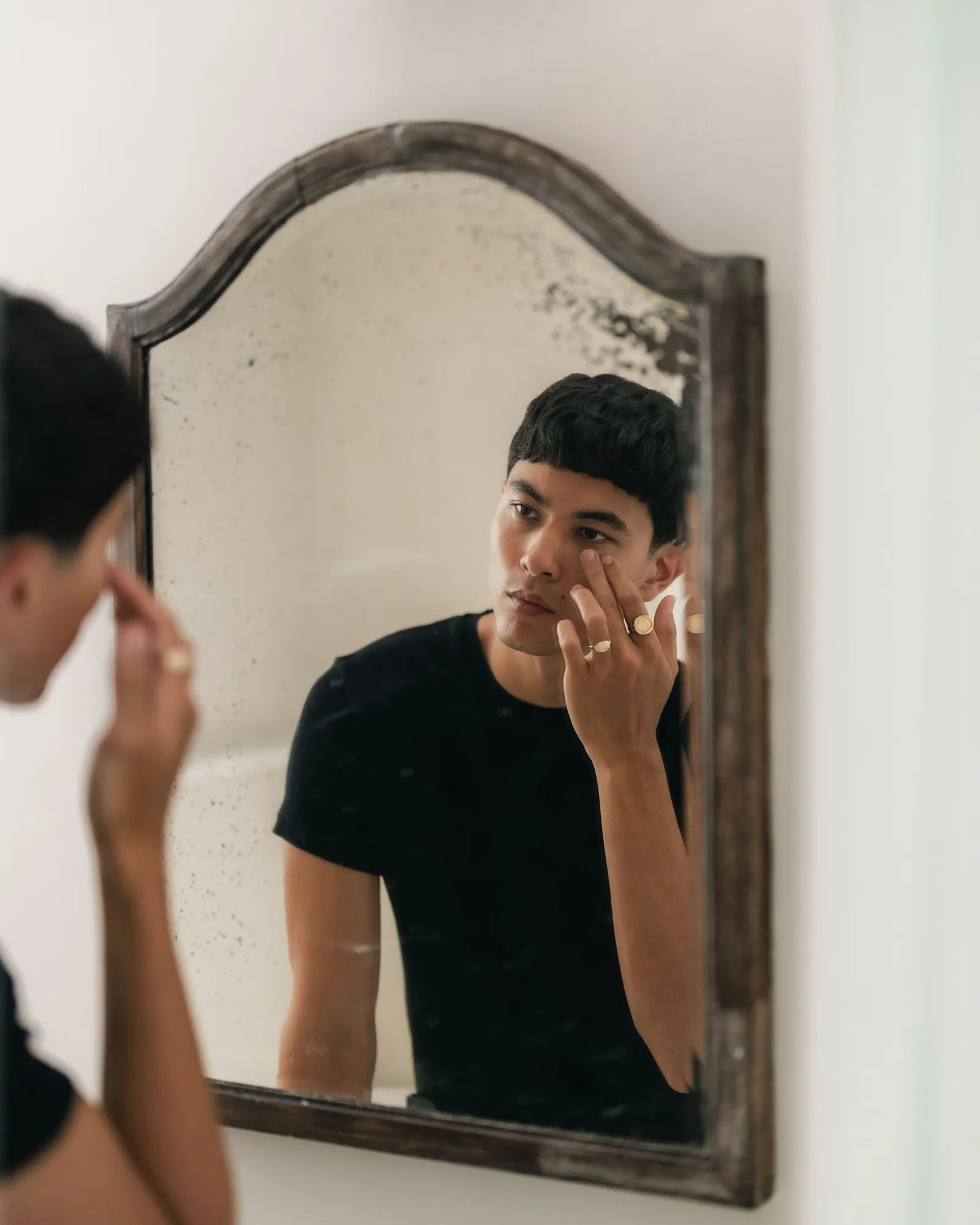 Advanced Eye Serum being applied at a bathroom mirror
