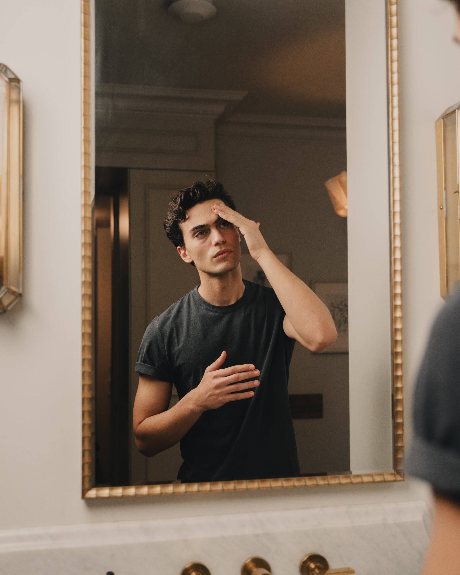 A man at the mirror, hydrated skin